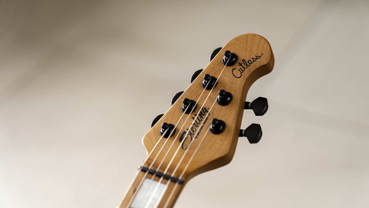 Guitar headstock with roasted maple and black tuning pegs