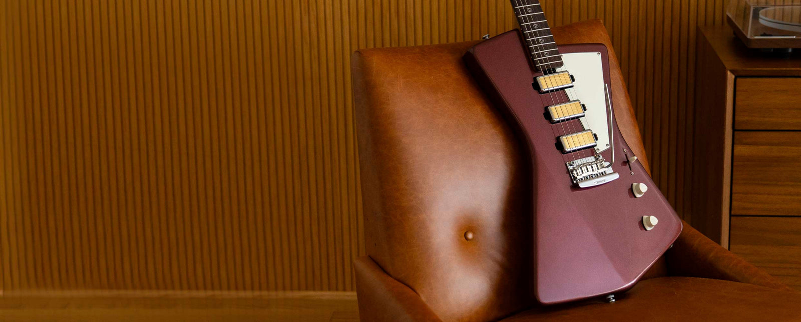 Burgundy electric guitar with three gold foil humbuckers