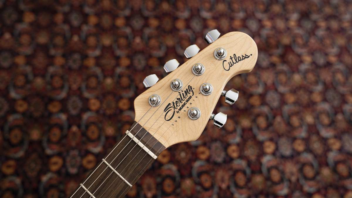 A guitar headstock with silver tuning pegs 