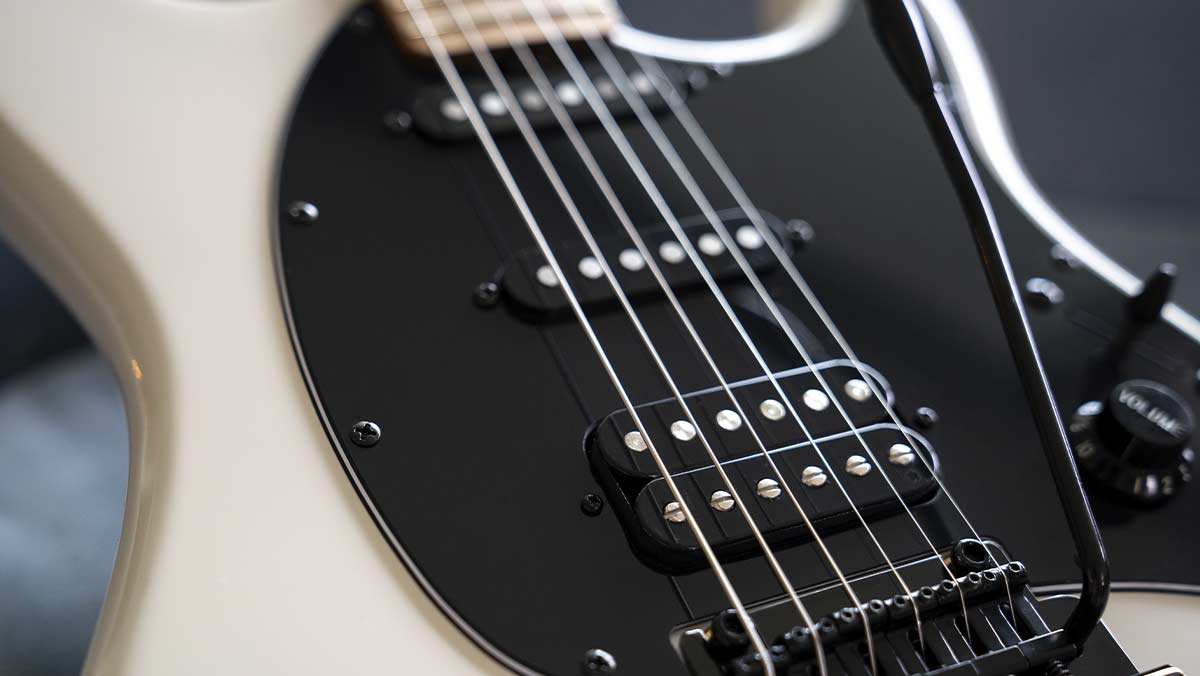 Closeup of an electric guitar with single coil pickups