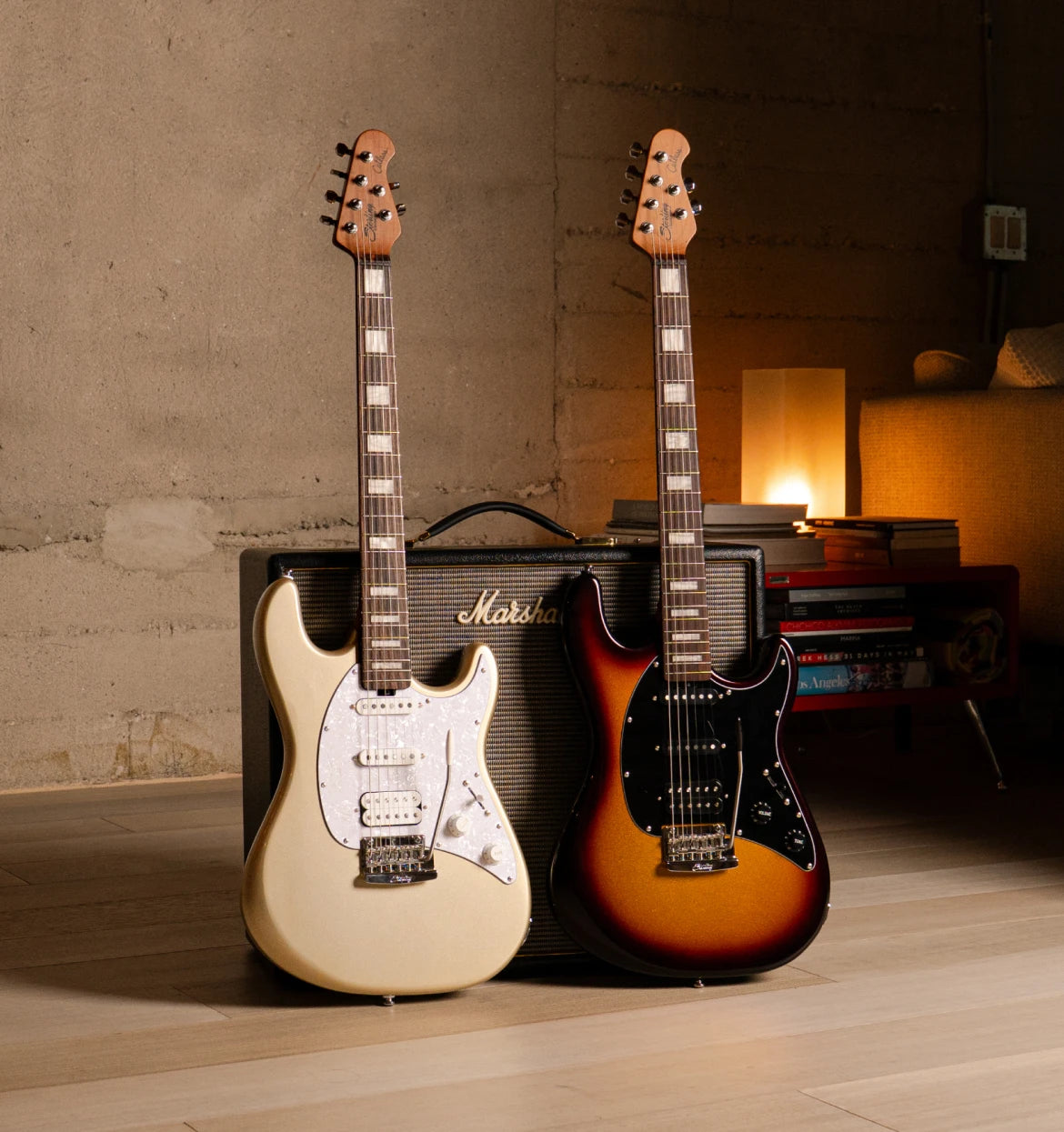 Two cutlass guitars in front of an amp