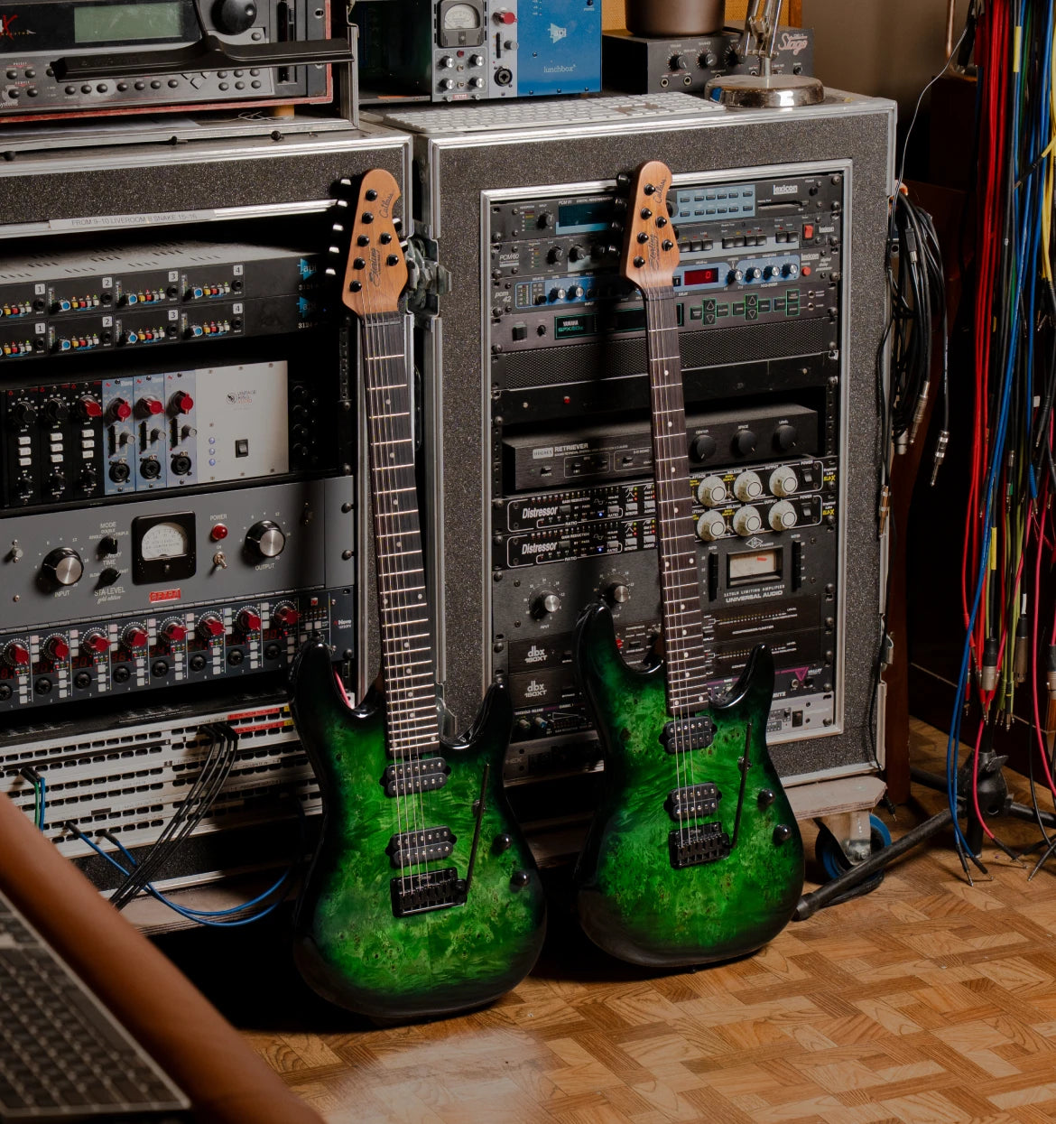 two richardson guitars in front of a control board